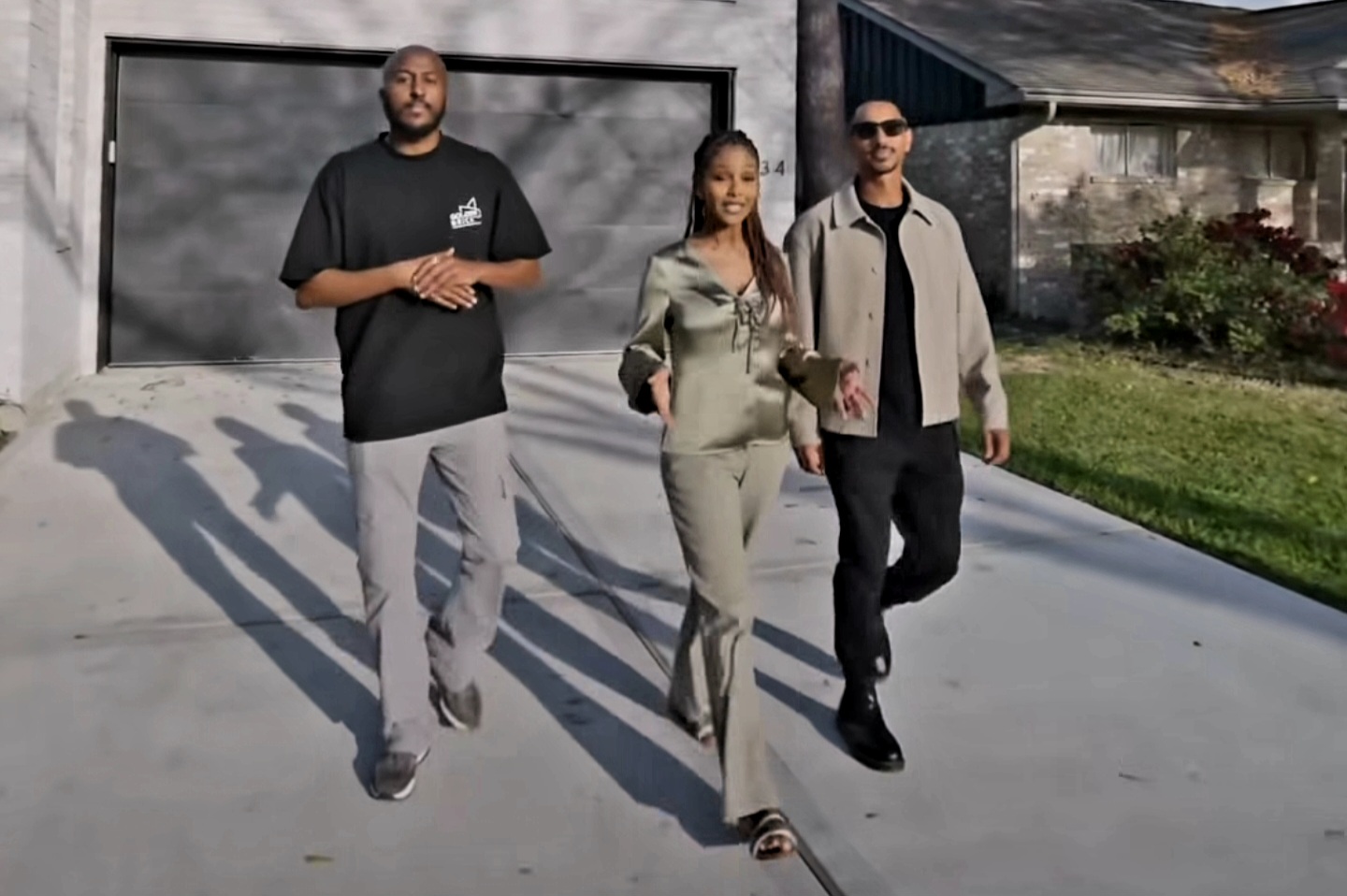 Members of the HIRE founding team walking together outside a home